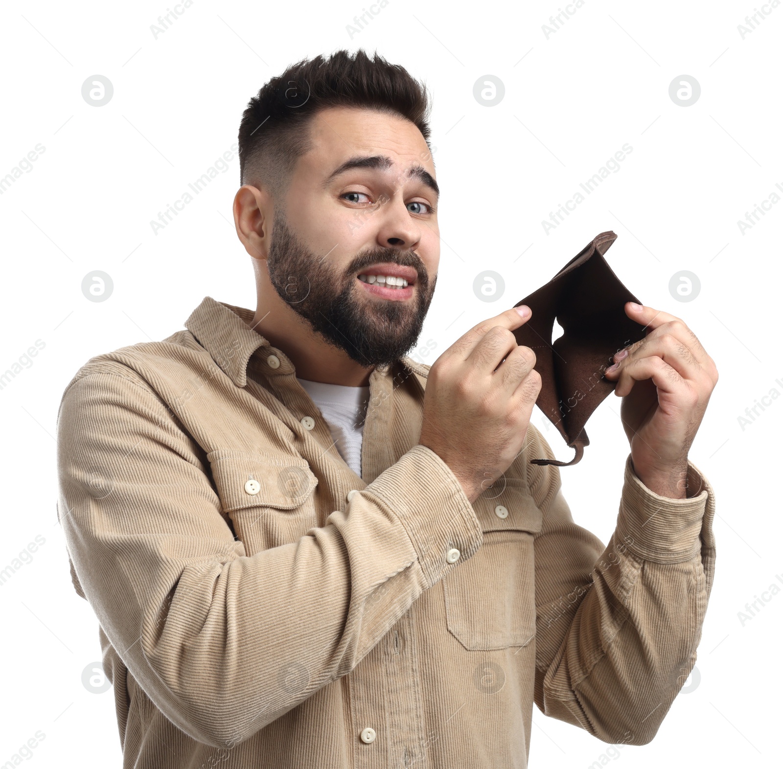 Photo of Confused man showing empty wallet on white background