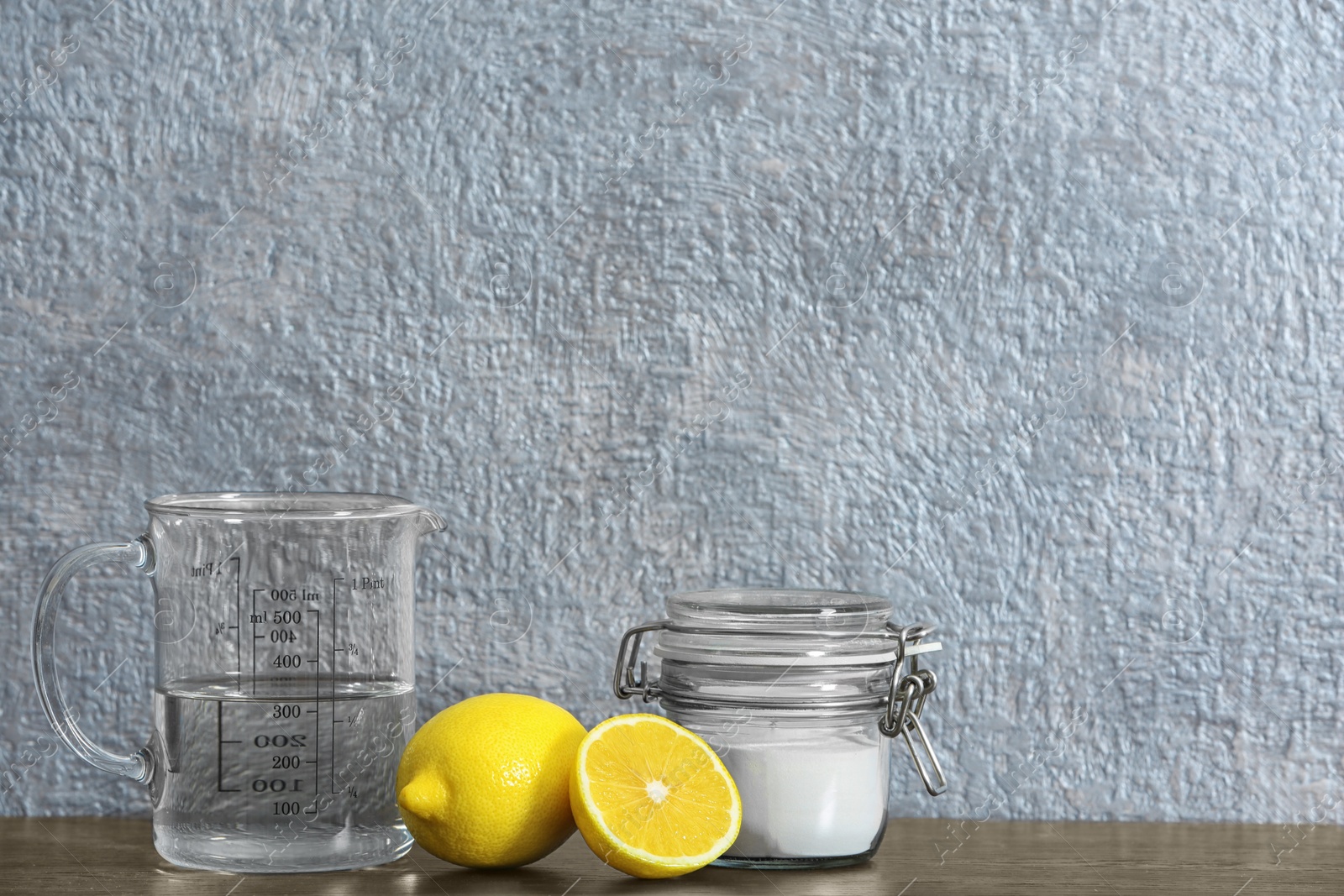 Photo of Composition with vinegar, lemons and baking soda on table. Space for text