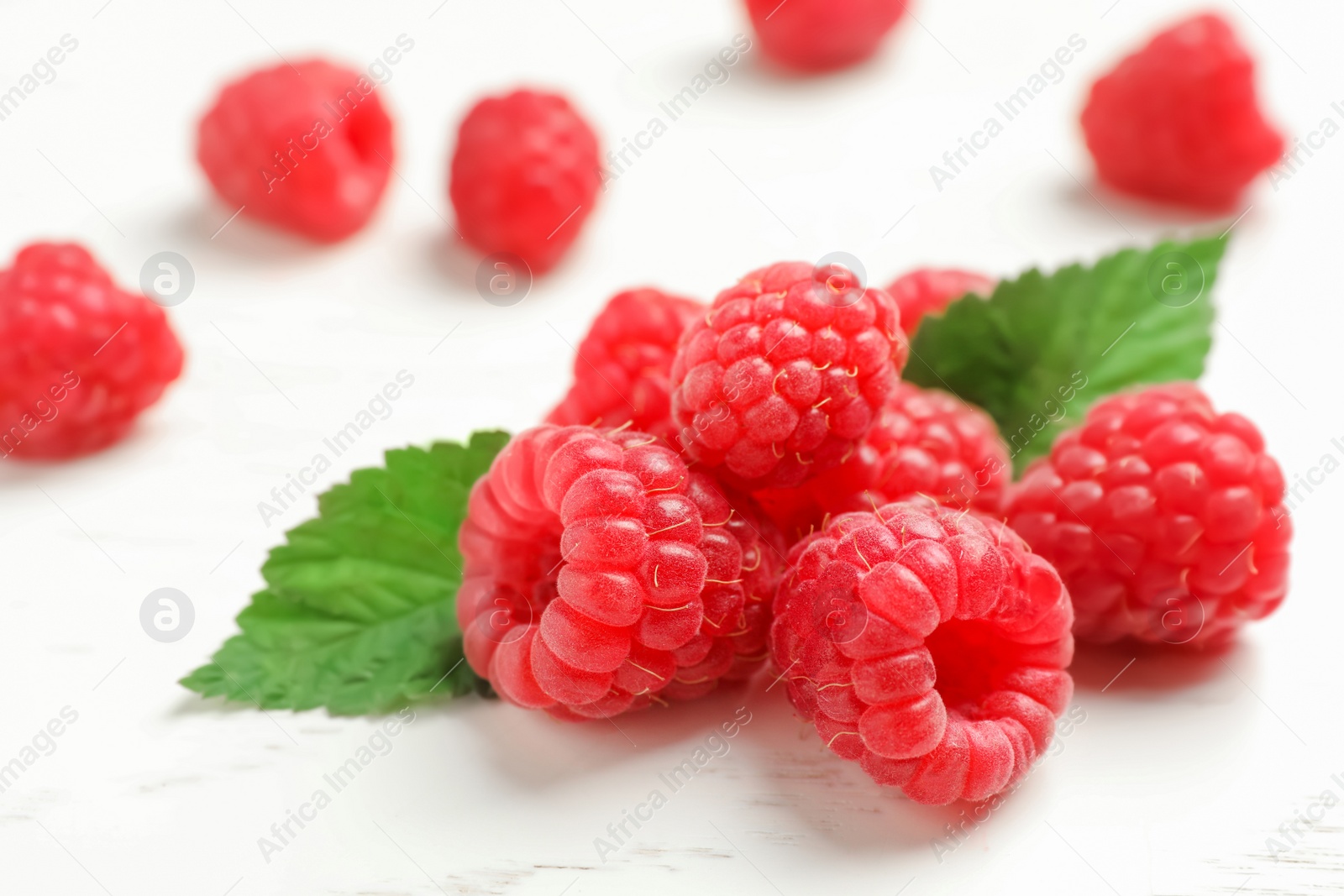 Photo of Ripe aromatic raspberries on table, closeup