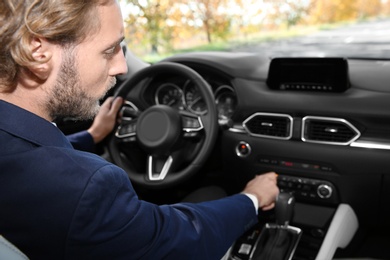 Young man in driver's seat of modern car