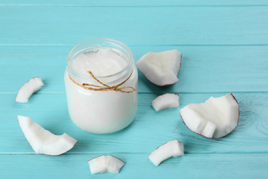 Photo of Composition with organic coconut oil on light blue wooden table. Healthy cooking