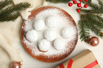 Flat lay composition with tasty Christmas snowball cookies on white table