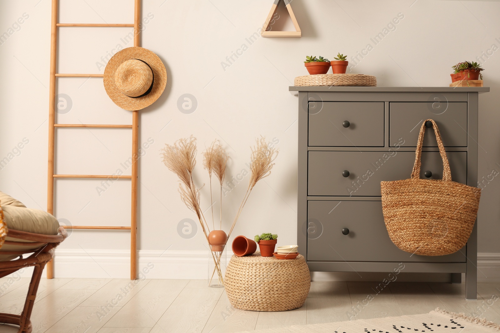 Photo of Grey chest of drawers in stylish room interior