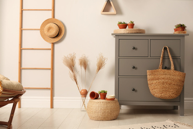 Photo of Grey chest of drawers in stylish room interior