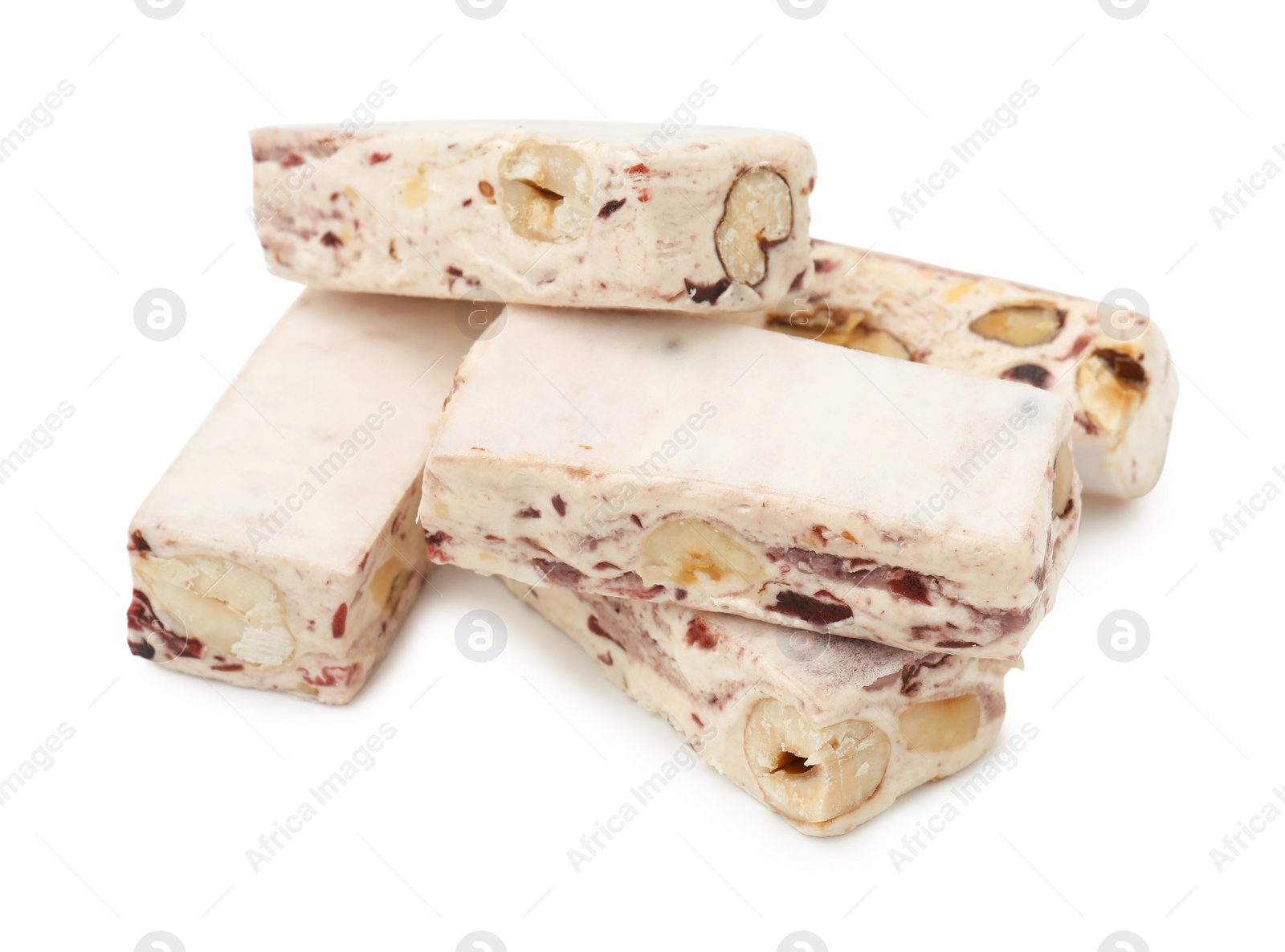 Photo of Many pieces of delicious nougat on white background