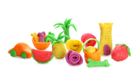Collection of small figures made from play dough on white background