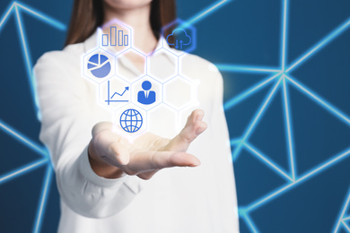 Image of  Woman demonstrating icons of data management system on blue background, closeup