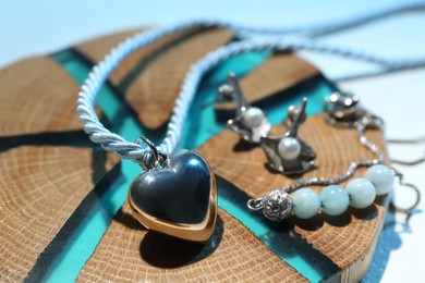 Photo of Stylish presentation of beautiful jewelry on color background, closeup