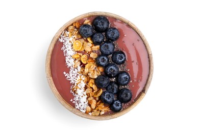 Photo of Bowl of delicious fruit smoothie with fresh blueberries, granola and coconut flakes isolated on white, top view
