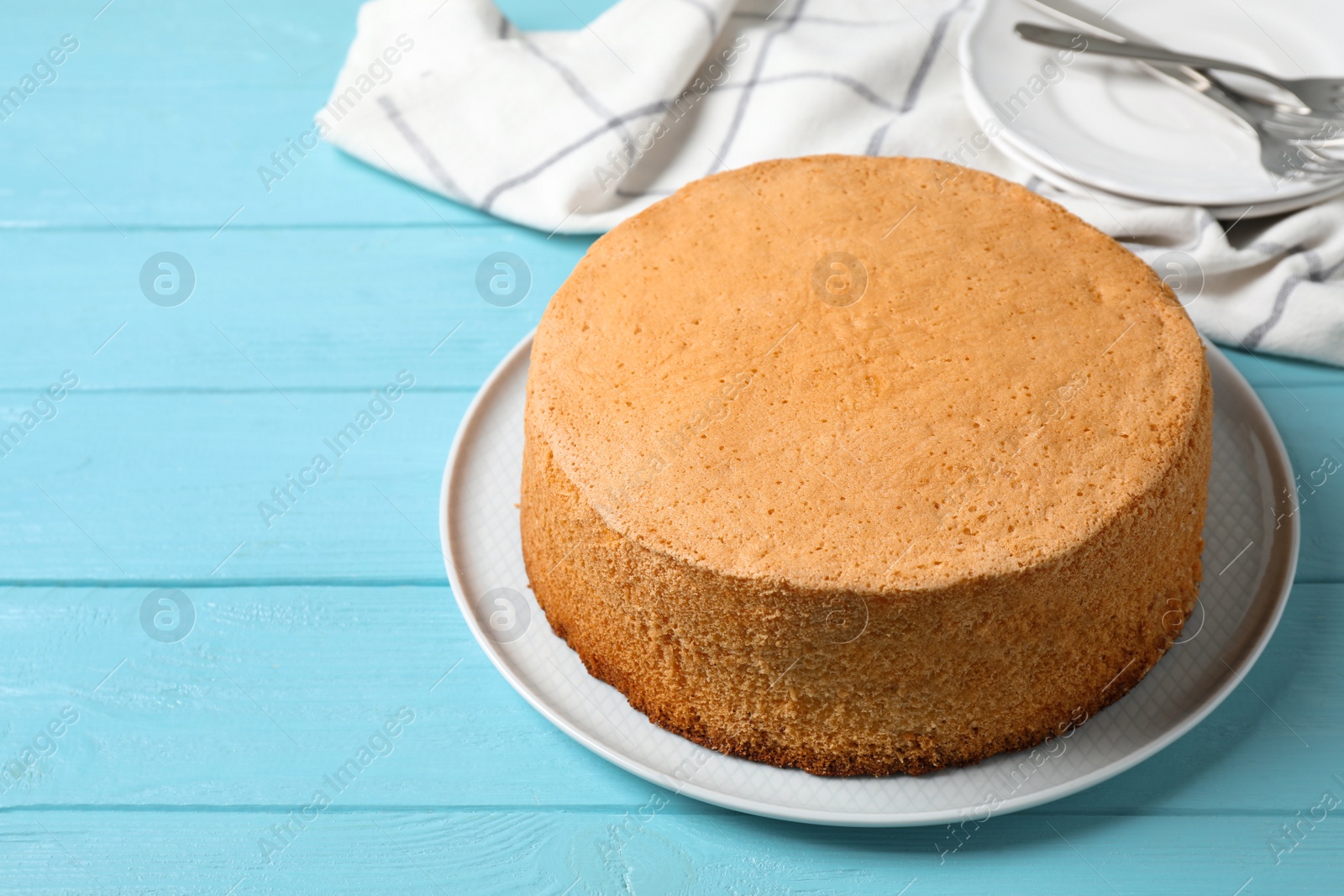 Photo of Delicious fresh homemade cake on light blue wooden table