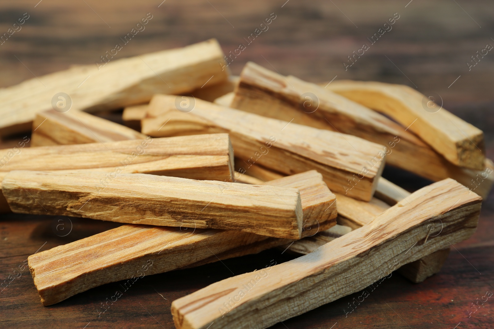 Photo of Many palo santo sticks on wooden table, closeup