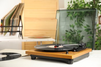 Stylish turntable and vintage vinyl records indoors