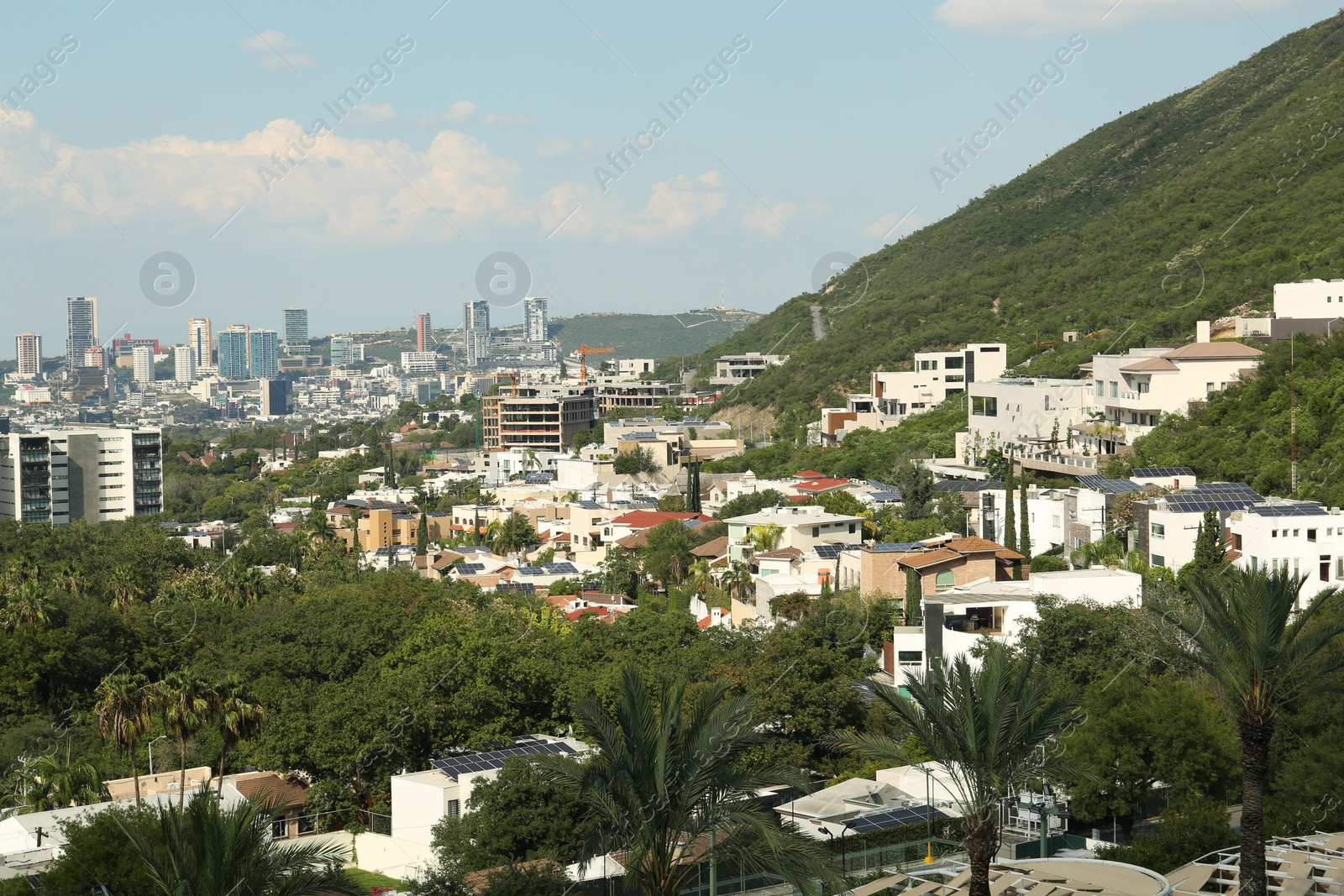 Photo of Picturesque view of city and green mountains