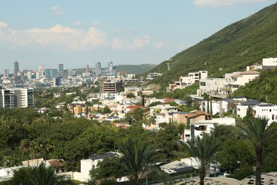 Photo of Picturesque view of city and green mountains