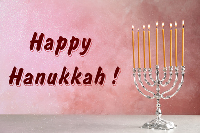 Image of Silver menorah on light table. Happy Hanukkah!