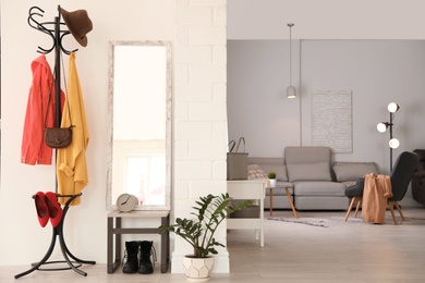 Stylish hallway interior with large mirror