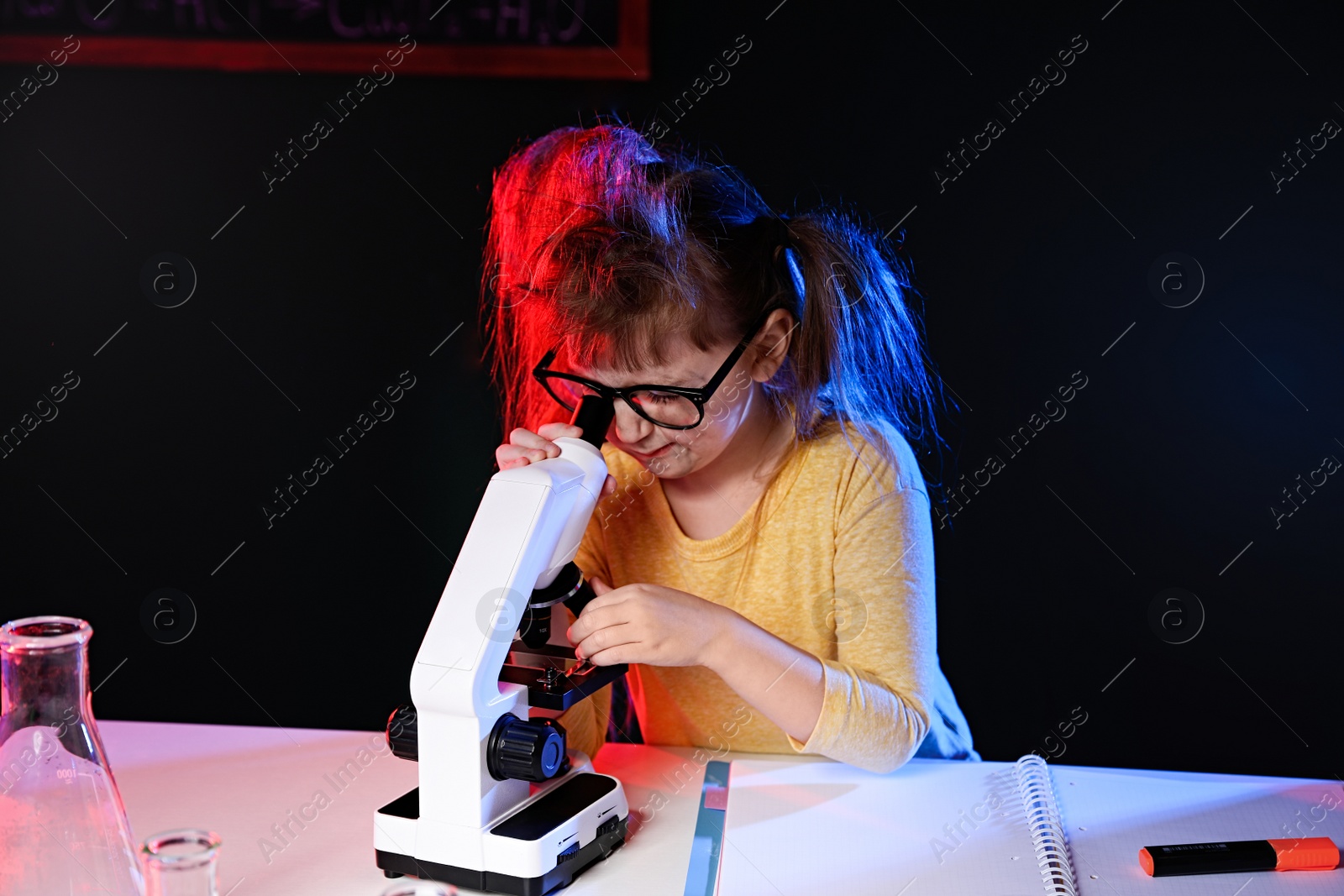 Photo of Child doing chemical research in laboratory. Dangerous experiment