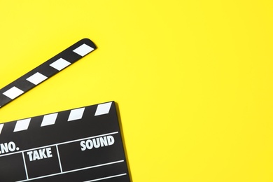 Clapperboard on color background, top view with space for text. Cinema production