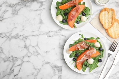 Photo of Flat lay composition of fresh melon with prosciutto on marble table. Space for text