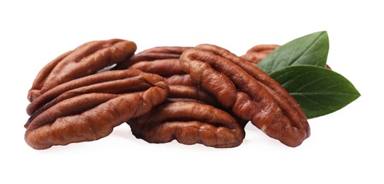 Photo of Many tasty pecan nuts with green leaves isolated on white