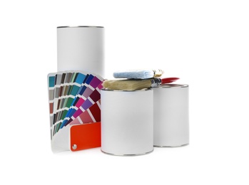 Photo of Closed blank cans of paint with brushes and palette isolated on white