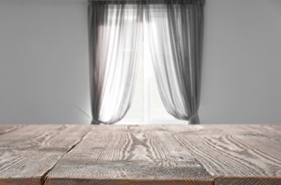 Image of Empty wooden table in room. Space for design