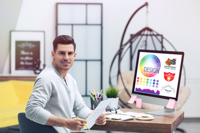 Image of Professional male designer working at desk in modern office