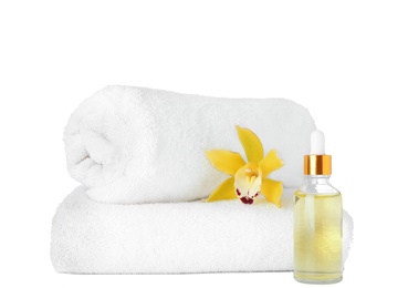 Photo of Fresh towels, essential oil and exotic flower isolated on white