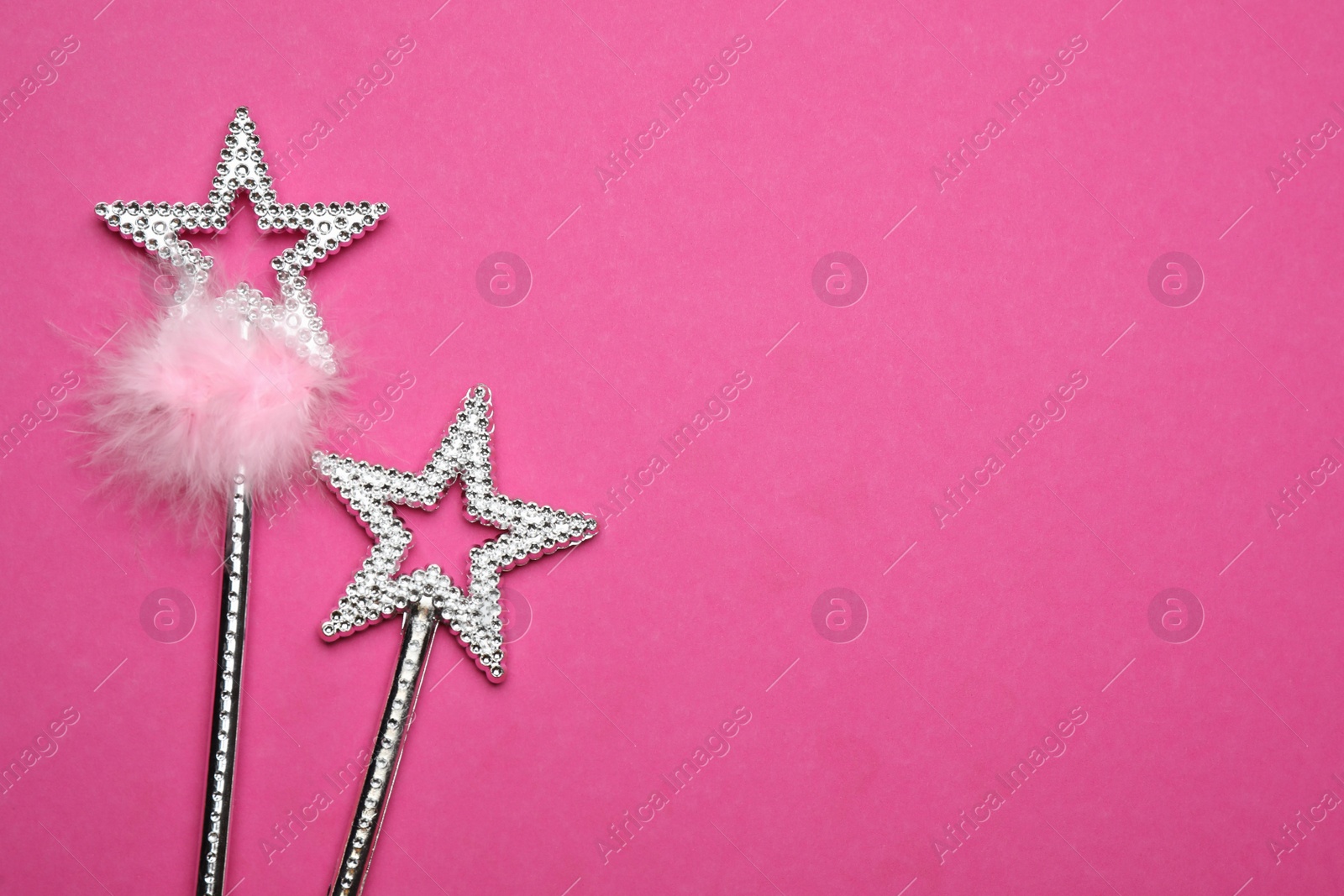 Photo of Beautiful silver magic wands on magenta background, flat lay. Space for text