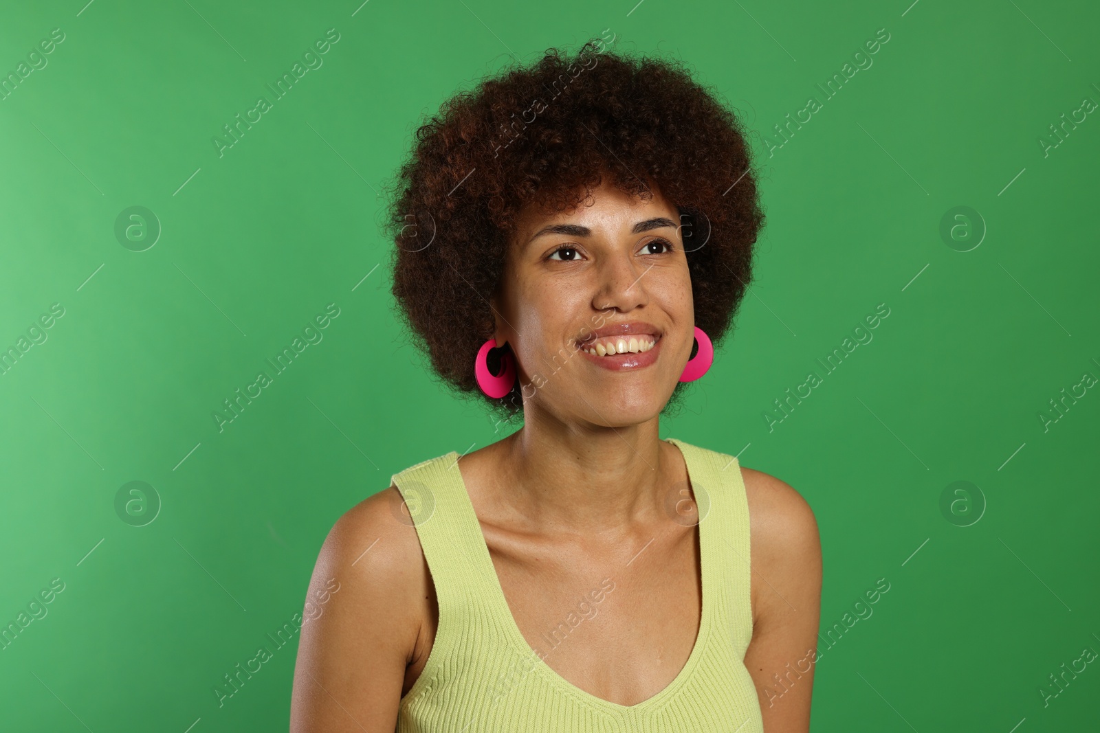 Photo of Portrait of happy young woman on green background