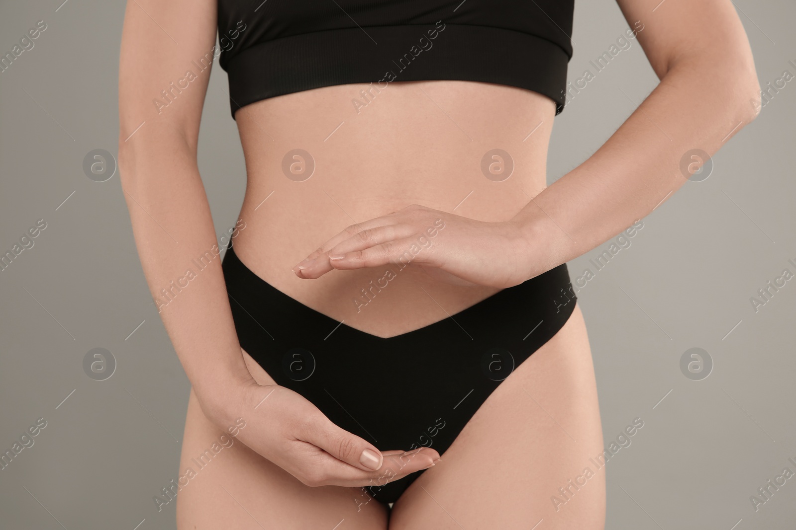 Photo of Gynecology. Woman in underwear on grey background, closeup