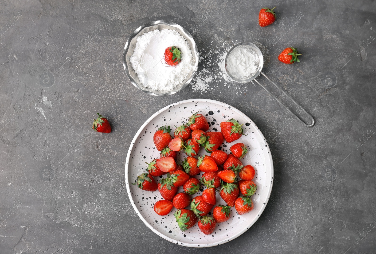 Photo of Flat lay composition with ripe red strawberries and sugar powder on grey background