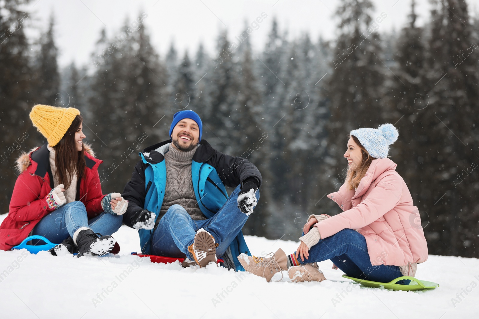 Photo of People with plastic sleds outdoors. Winter vacation