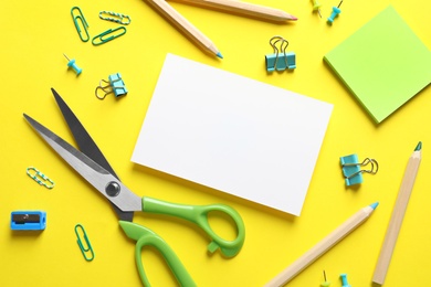 Photo of Flat lay composition with scissors and office supplies on color background. Space for text