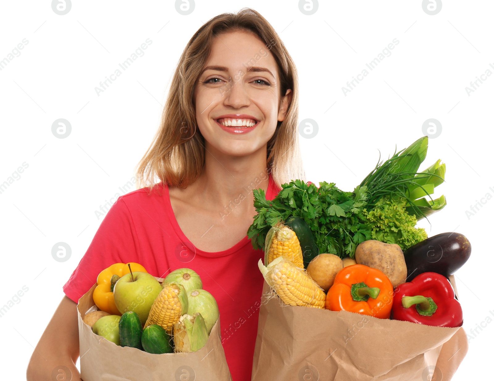 Photo of Young woman with bags of fresh vegetables isolated on white