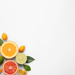 Photo of Fresh juicy citrus fruits with green leaves on light background, flat lay. Space for text