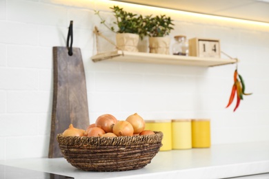 Photo of Fresh onions on countertop in modern kitchen