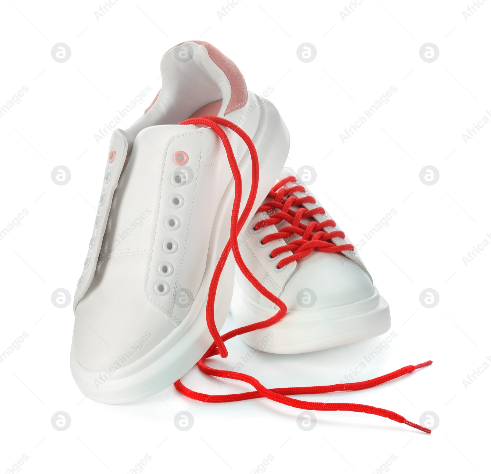 Photo of Stylish sneakers with red shoelaces on white background