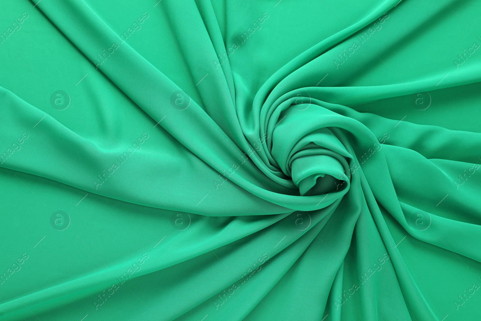 Photo of Beautiful green tulle fabric as background, top view