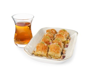 Photo of Delicious baklava with pistachios and hot tea on white background