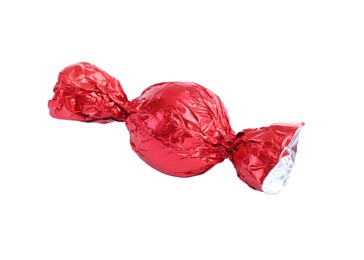 Tasty candy in red wrapper isolated on white