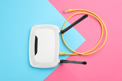 Photo of Modern Wi-Fi router on color background, top view