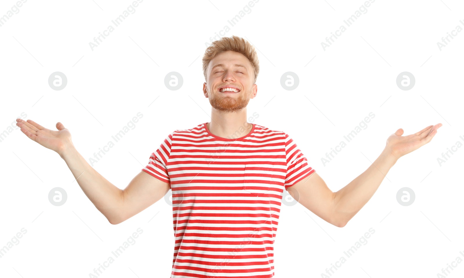 Photo of Young man with air conditioner remote on white background