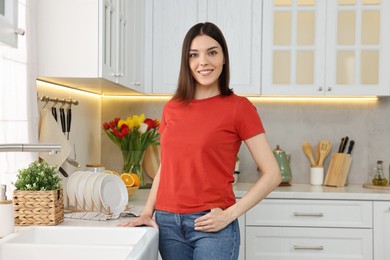 Photo of Portrait of beautiful young woman in kitchen