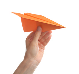 Woman holding orange paper plane on white background, closeup