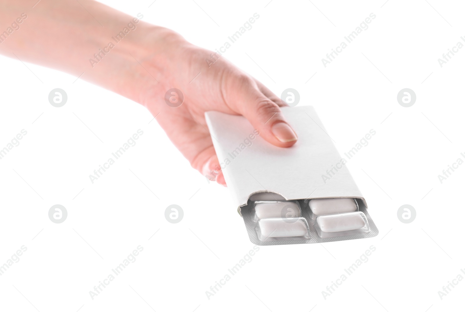 Photo of Woman holding blister with chewing gums on white background, closeup