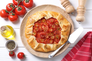 Photo of Flat lay composition with tasty tomato galette (Caprese galette) on white wooden table