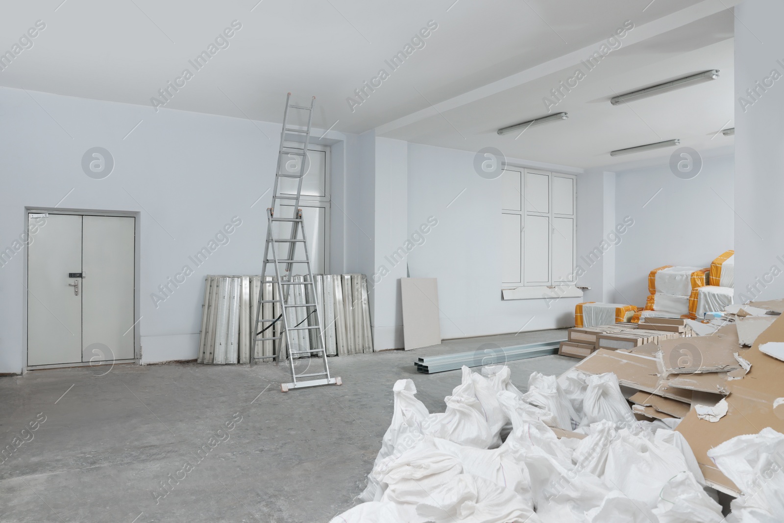 Photo of New and used building materials in room prepared for renovation