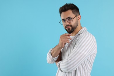Photo of Handsome man wearing glasses on turquoise background, space for text
