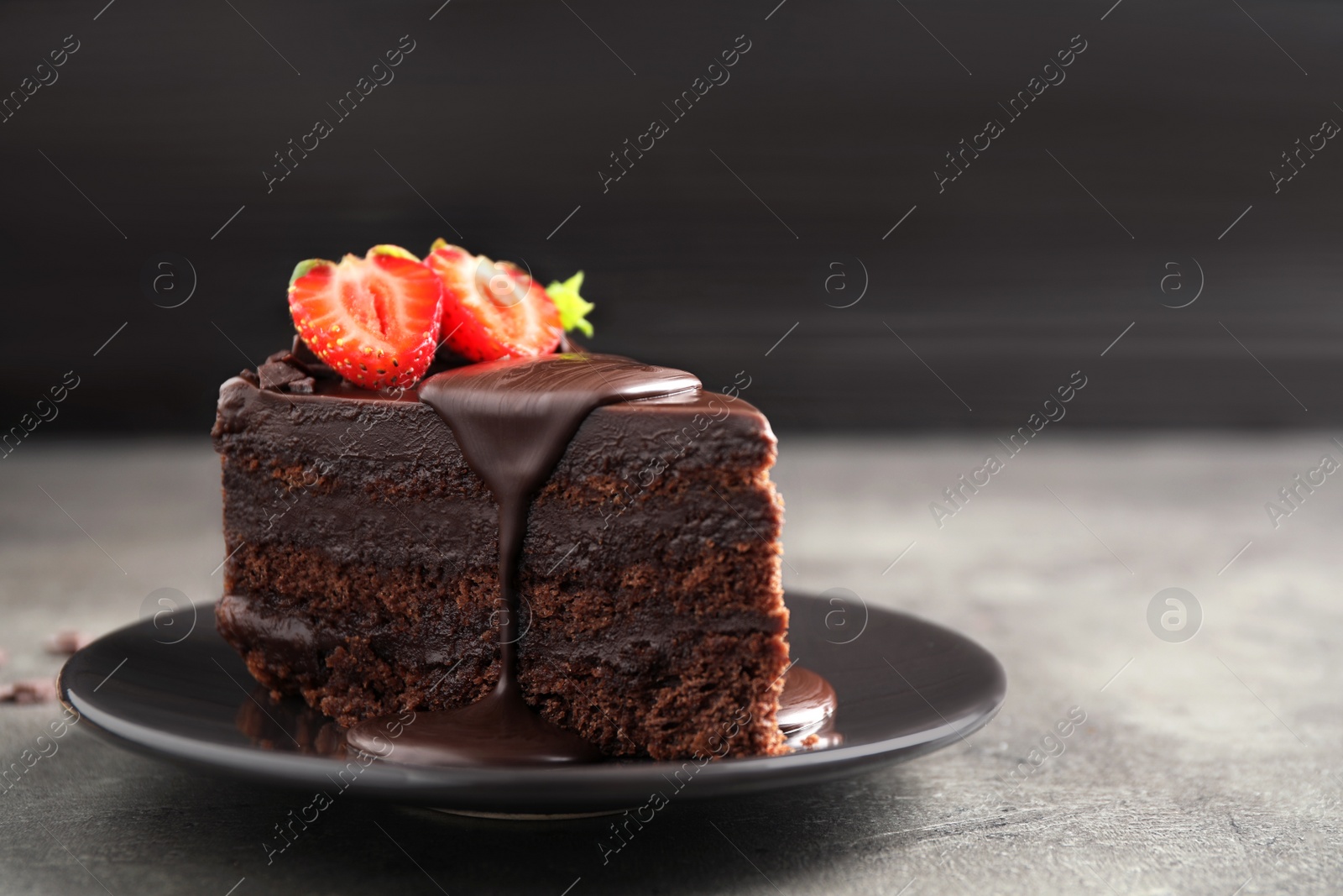 Photo of Delicious fresh chocolate cake with strawberry on grey table